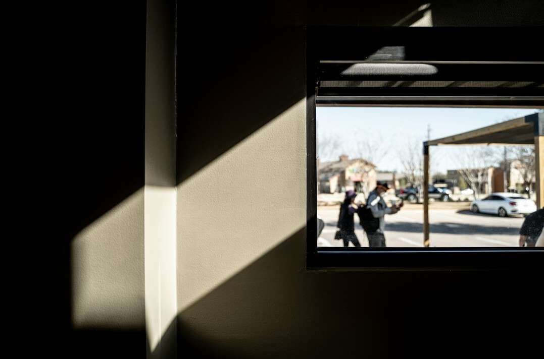 Small group of executives having a quiet conversation by a window