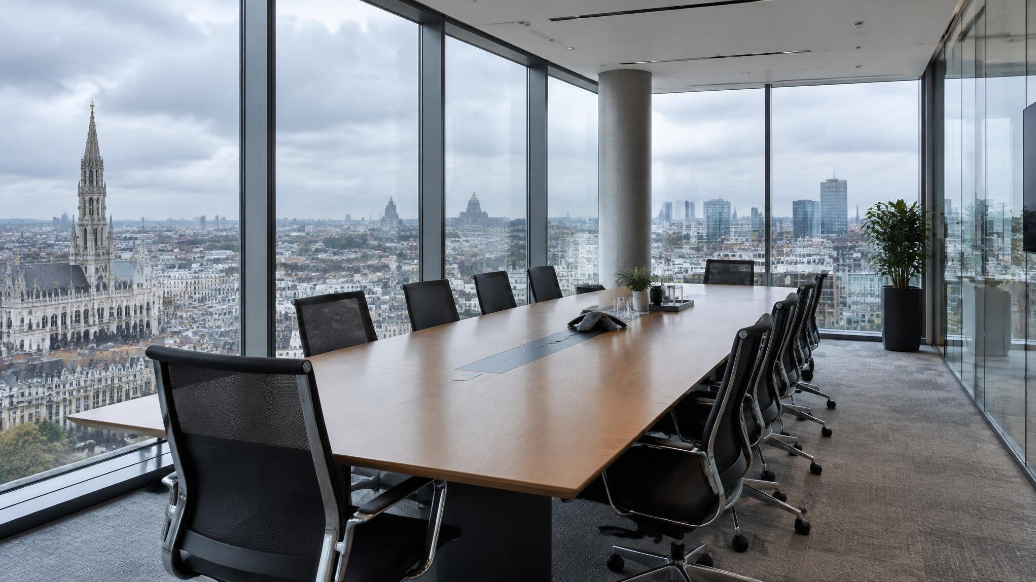 Executives in a modern glass boardroom discussing strategy